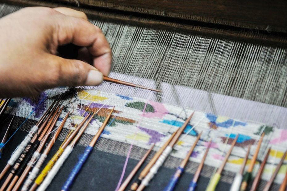 Unsung artistsA Kashmiri craftsman weaves a Kani shawl with wooden needles and thread made out of Pa