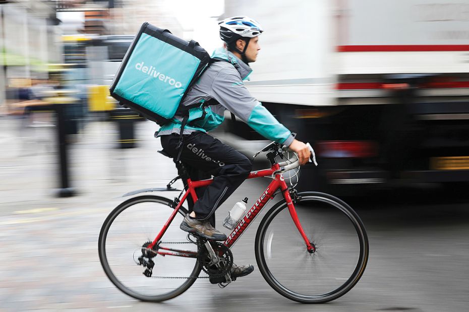 Wheels of changeA Deliveroo rider cycles through central London to make a food delivery. Millions of