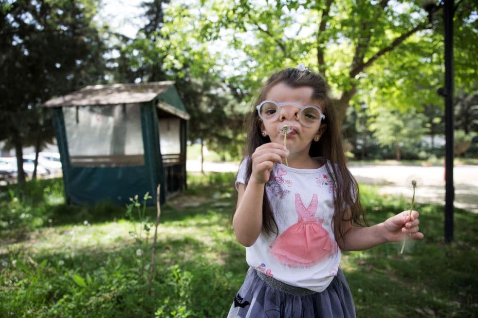 Four year old Elif Ada, born with a visual impairment due to a genetic disease poses for a photo wit