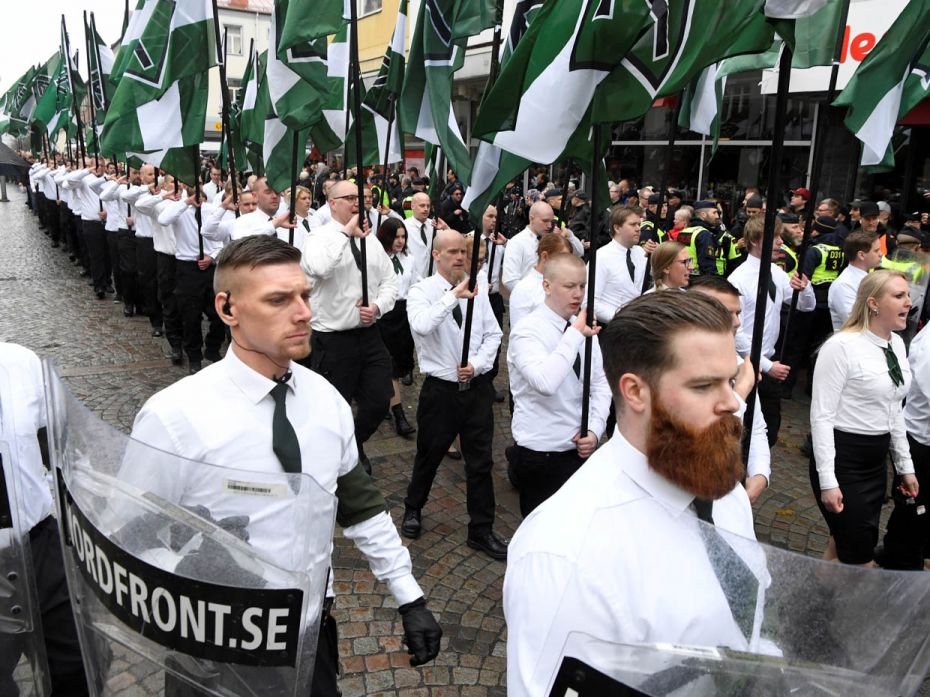 Members of the violent and rapidly expanding white supremacist Nordic Resistance Movement march thro