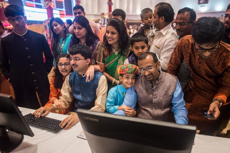 A stockbroker, with his family gathered around him, trades during a special "mahurat" trad