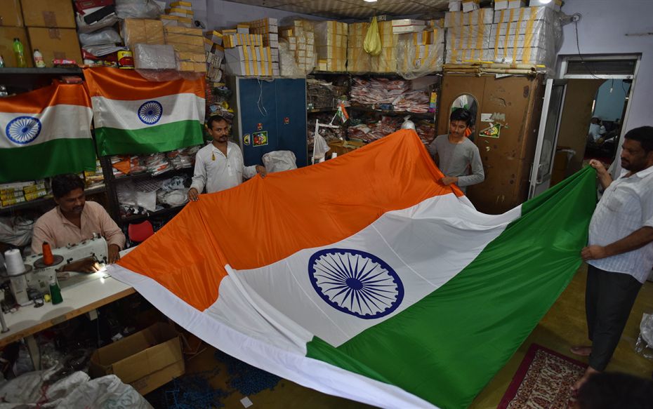 A tailor stitches the national flag at Sadar Bazaar, on August 11, 2019 in New Delhi, India