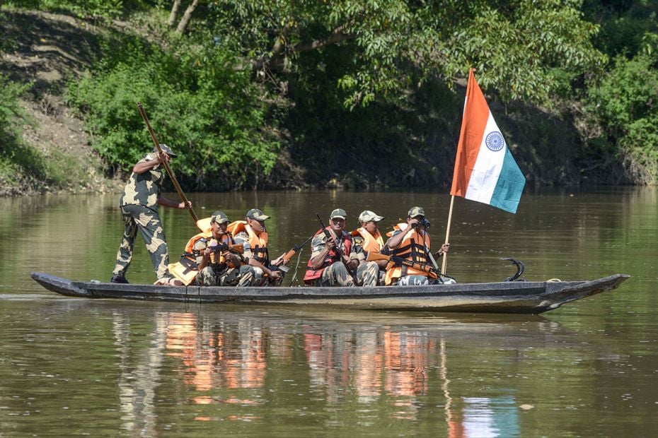 Border Security Force (BSF) personnel keep a boat vigil on the Gomati river near the India-Banglades