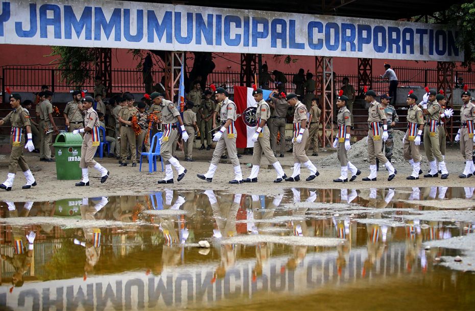 In Jammu, police personnel walk together after a full dress-rehearsal of the Indian Independence Day