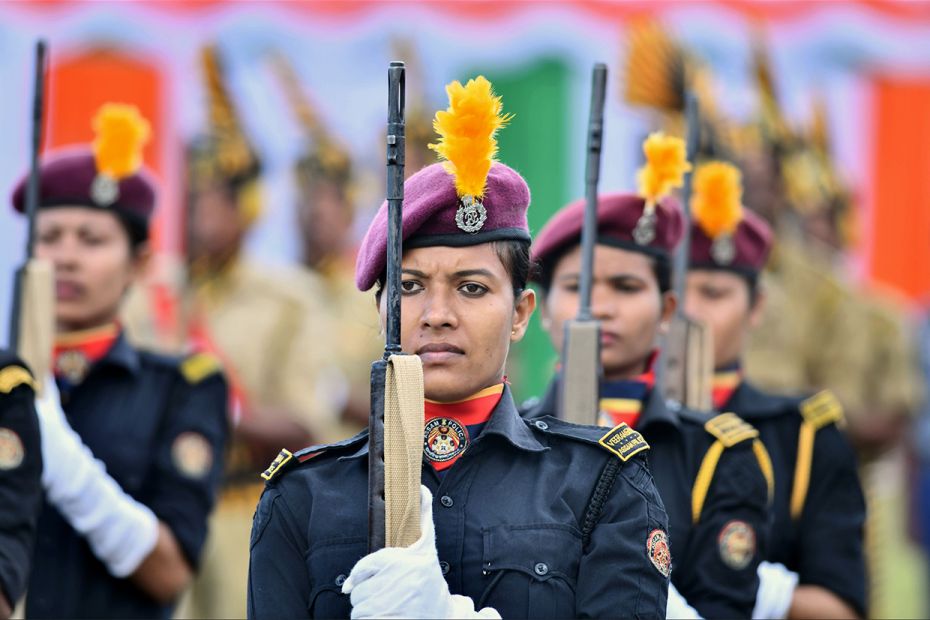 Assam police stand with their guns during a full-dress rehearsal for Independence Day celebrations i