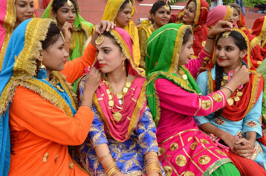 Indian school girls get ready to perform a Punjabi folk dance, 'Giddha', for Independence Day at Gur