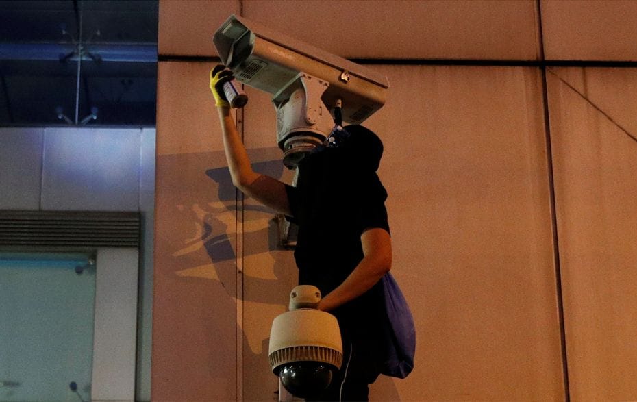 July 21, 2019: Pro democratic reforms protester sprays CCTV camera outside the Chinese liaison offic