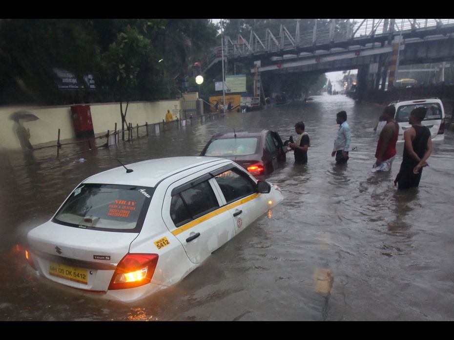 A taxi is seen stuck at a waterlogged street during heavy rains in Mumbai, India on July 1, 2019. Mo