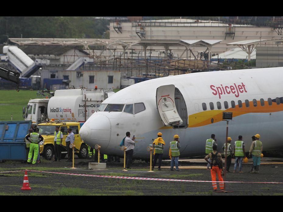 A SpiceJet Boeing 737-800 airplane is seen after it overshot the runway while landing due to heavy r