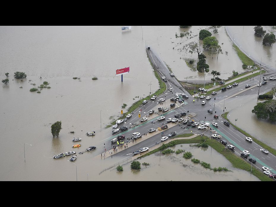 Seen is a general view of a major intersection blocked in the flooded Townsville suburb of Idalia on