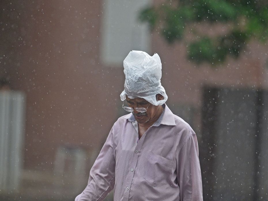 People deal with heavy rain in innovative ways, as seen in Goregaon, on June 24.