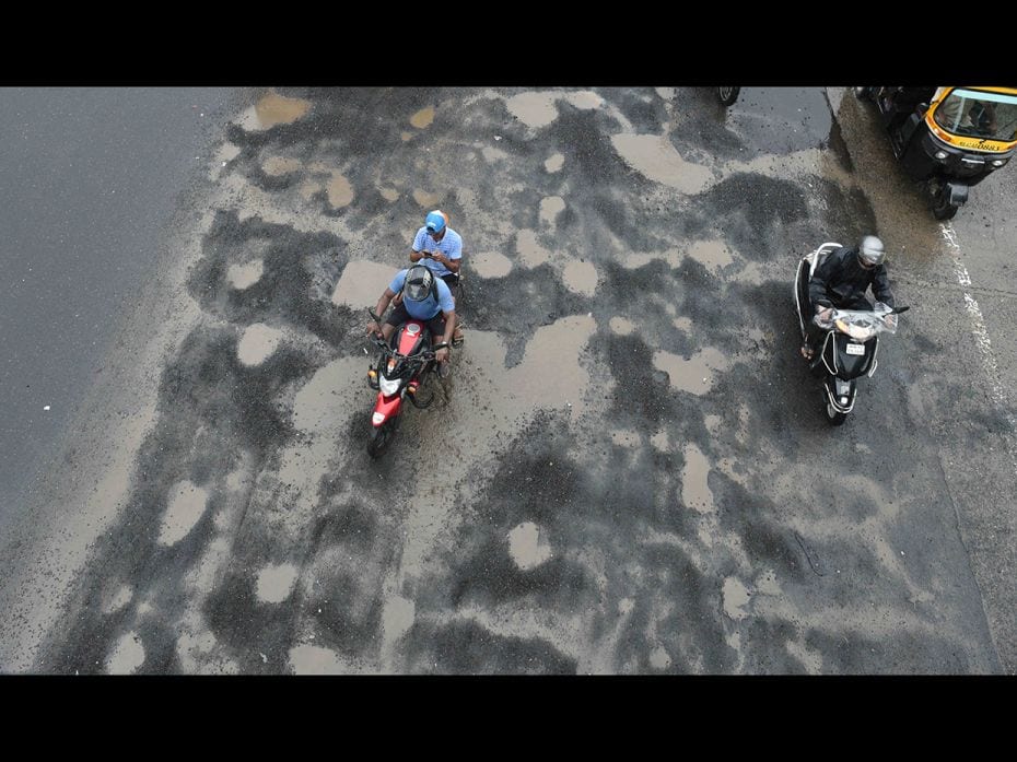 Potholes appear after a heavy rainfall at Western Express Highway, Vile Parle, on June 29. The overn