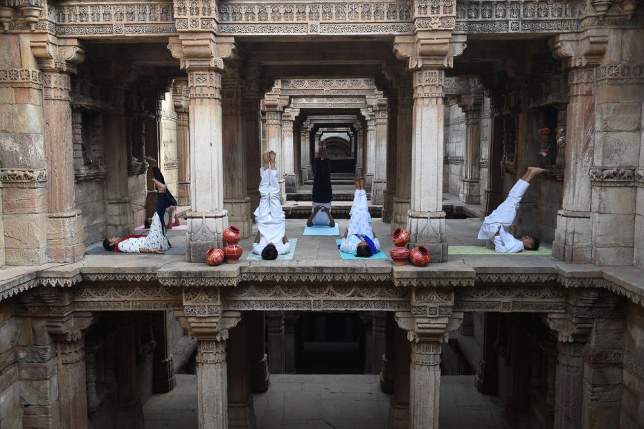 Indian yoga practitioners take part in a session on International Yoga Day at the 15th century Stepw