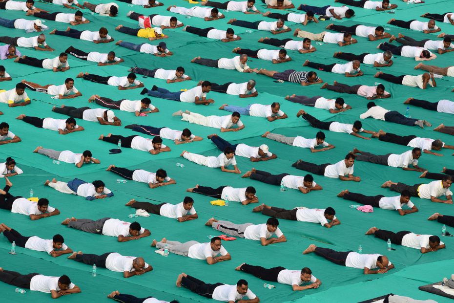 Yoga enthusiasts relax between asanas at a yoga session on International Yoga Day in Allahabad