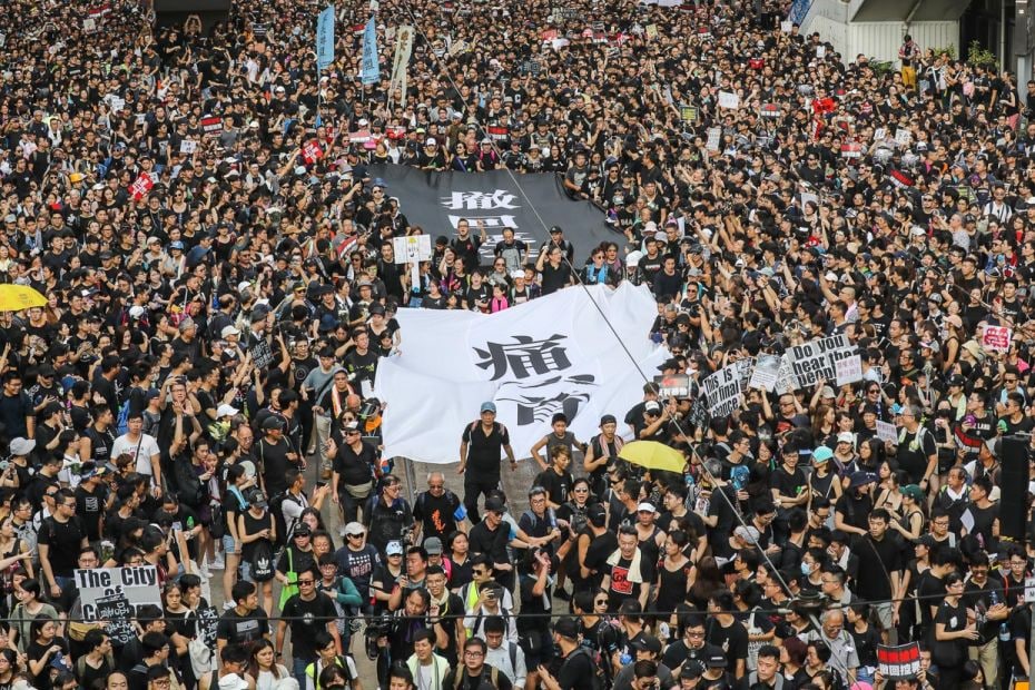 Protesters march to the Central Government Offices in Hong Kong, calling on Chief Executive Carrie L