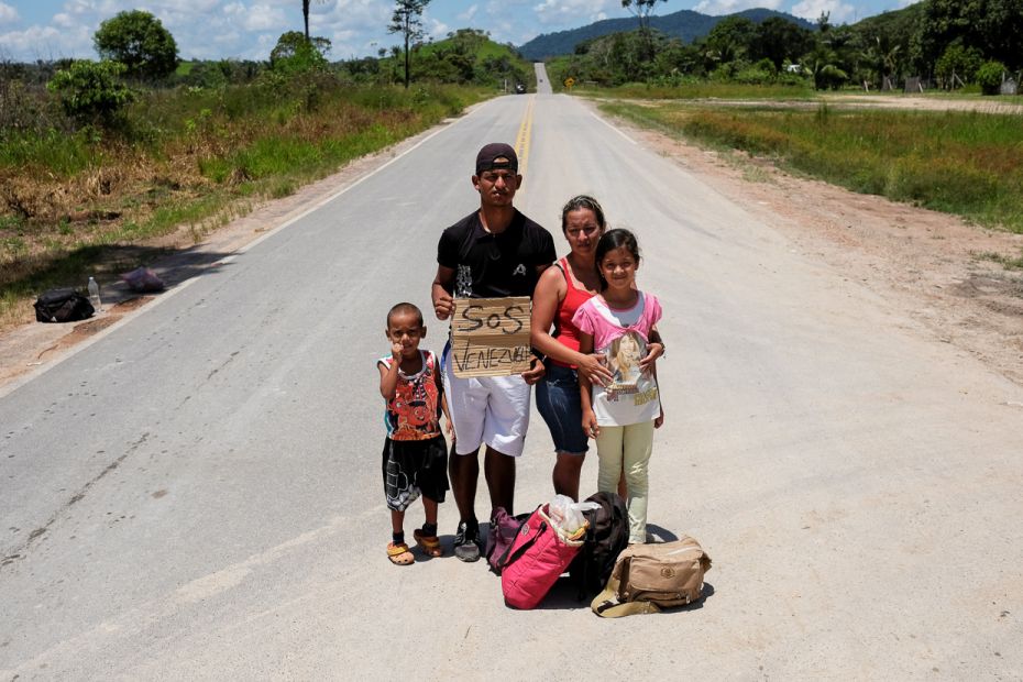 A Venezuelan family from Aragua state poses for a picture after they obtained refugee status or temp