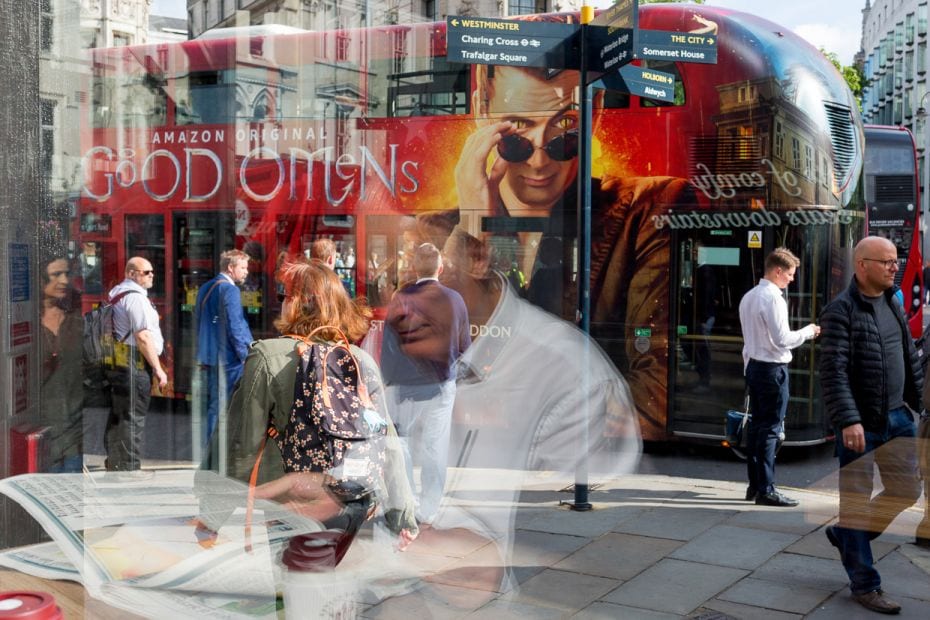 A businessman flips through a newspaper at a cafe during the morning rush-hour in London. Britain&rs