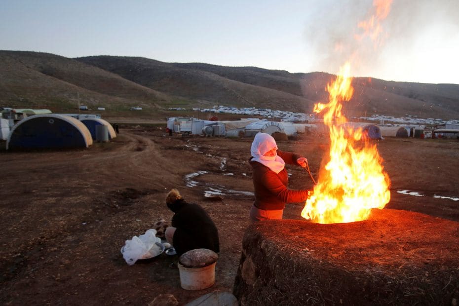 A Yazidi woman makes bread at a refugee camp in Mount Sinjar, Iraq. Yazidi women were brutalised by 