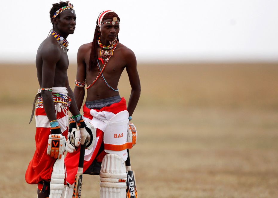 KenyaSonyanga Olengais (left), captain of the Maasai Cricket Warriors, talks to his teammate Mamai S