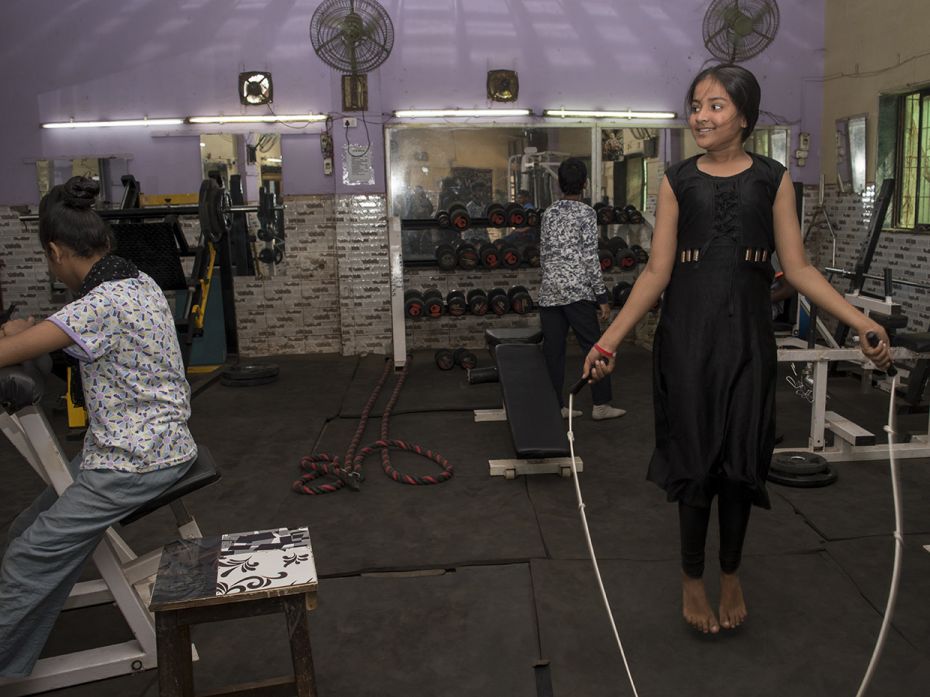 Shamma (14) shares a moment with Bhavani (15), while skipping rope at the local gym in Mankhurd, Mum