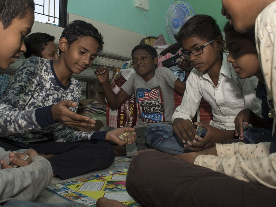 Irfan (14), is seen strategising his next move in the board game ‘Business’, playing wit