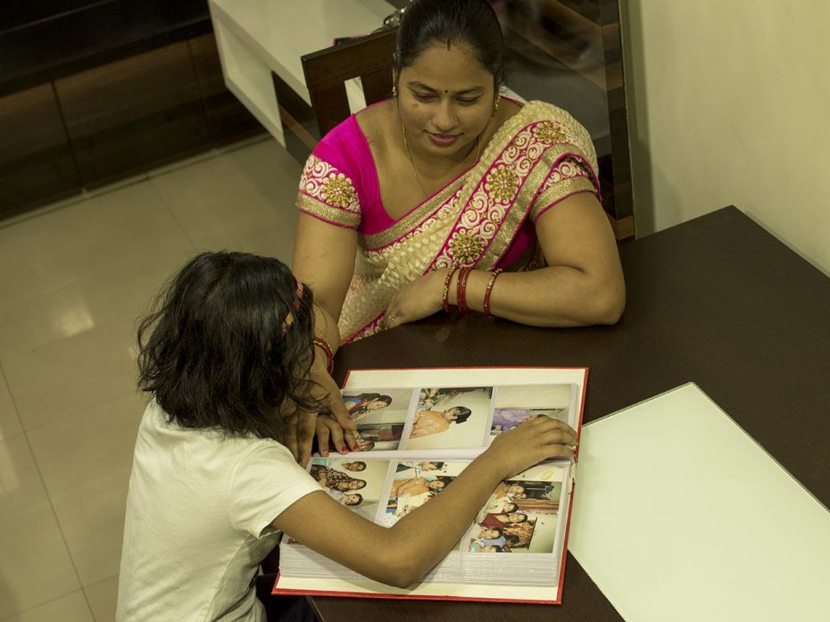                         Tanishka(9) goes through photographs of her first birthday party, along with