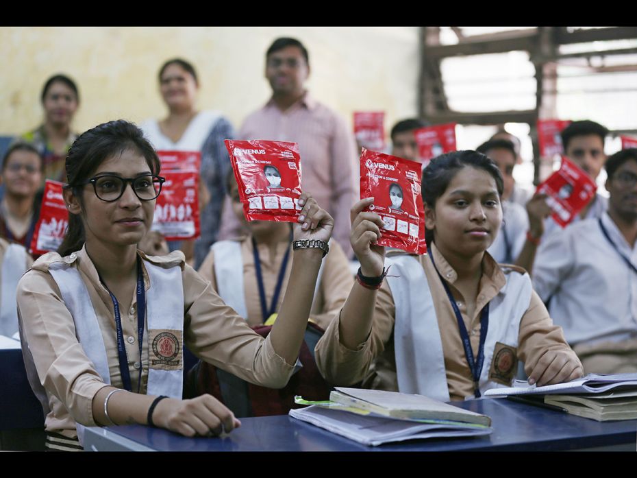 NEW DELHI, NOVEMBER 1: Students show off masks given to them at an event by Delhi Chief Minister Arv