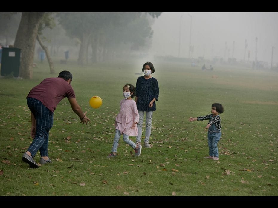 NEW DELHI, NOVEMBER 3: Children wear masks as they play at India Gate Lawns, ironically, a place to 