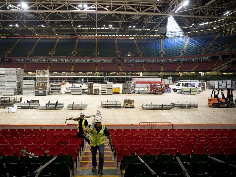 CARDIFF, WALES: Workers prepare the Dragon's Heart hospital on April 9, 2020, in Cardiff, Wales. The