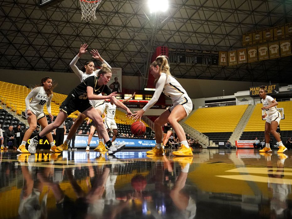 LONG BEACH, USA: Cal Poly Mustangs forward Alicia Roufosse, left, grabs a rebound from Long Beach St