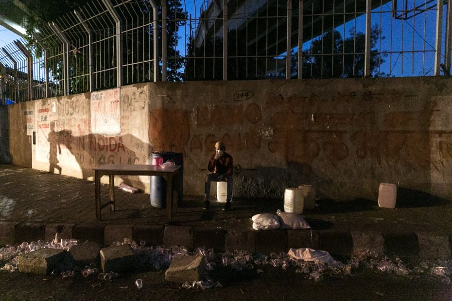 Riyaj sits down after an afternoon spent handing out cups of water to families on a long walk back t