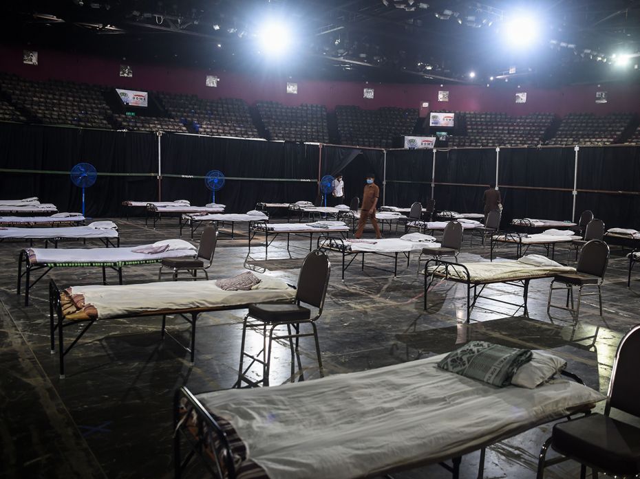 MUMBAI, INDIA: Brinhanmumbai Municipal Corporation (BMC) workers prepare an isolation centre at the 