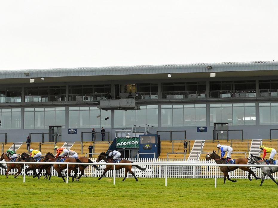 KILDARE, IRELAND: Horses ride past the empty grandstand at the Naas Racecourse. Covid-19 pandemic fo