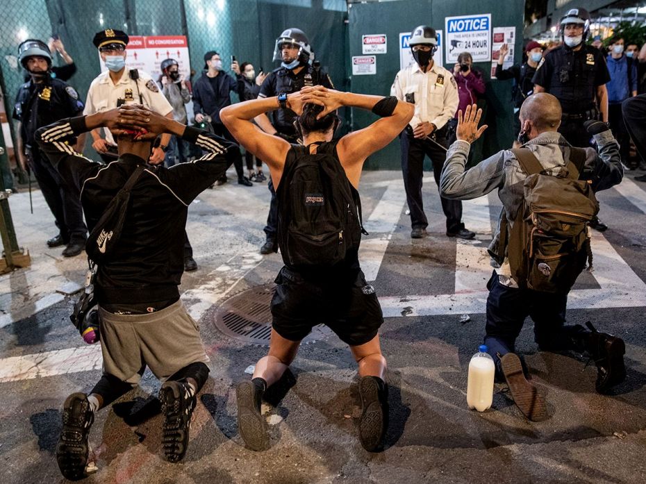 NEW YORK, NEW YORK - MAY 31: Protesters kneel in front of New York Police during a march to honour G