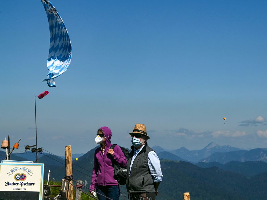 LENGGRIES, GERMANY – JUNE 1: People with protective masks stand in front of a beer garden rest