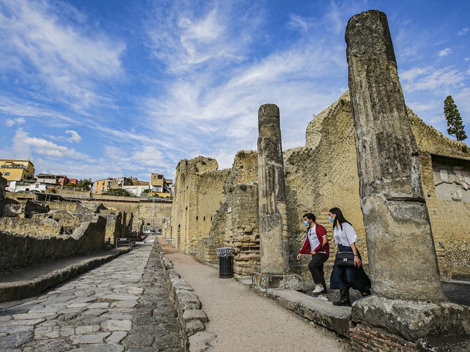 CAMPANIA, ITALY – JUNE 2: Tourists wearing protective masks visit the just reopened Herculaneu