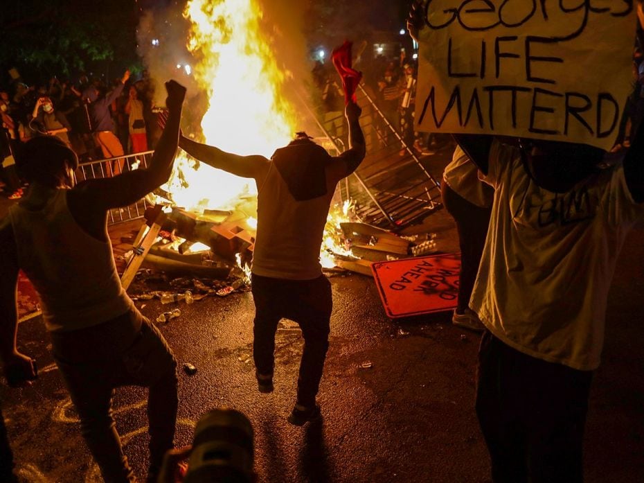 WASHINGTON, DC - MAY 31: Demonstrators gather around a fire during a protest near the White House in