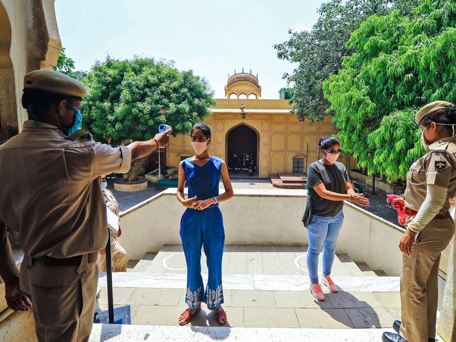 Tourists undergo thermal screening at Hawa Mahal after the authorities are permitted to open monumen