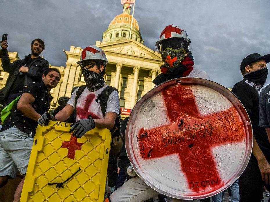 DENVER, CO - MAY 31: People acting as medics stand in front of the Colorado State Capitol during the