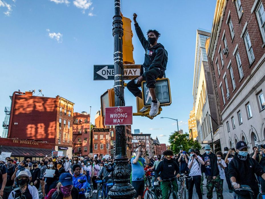 NEW YORK, NEW YORK - MAY 31: A Black Lives Matter protester raises his fist during a march to honour