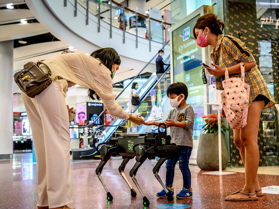 BANGKOK, THAILAND – June 4: A 5G K9 robot distributes hand sanitiser to visitors in a shopping