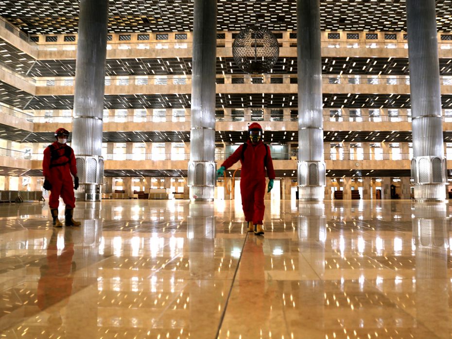 JAKARTA, INDONESIA - JUNE 3: Officers spray disinfectant in the Istiqlal Mosque, Jakarta, as the cou