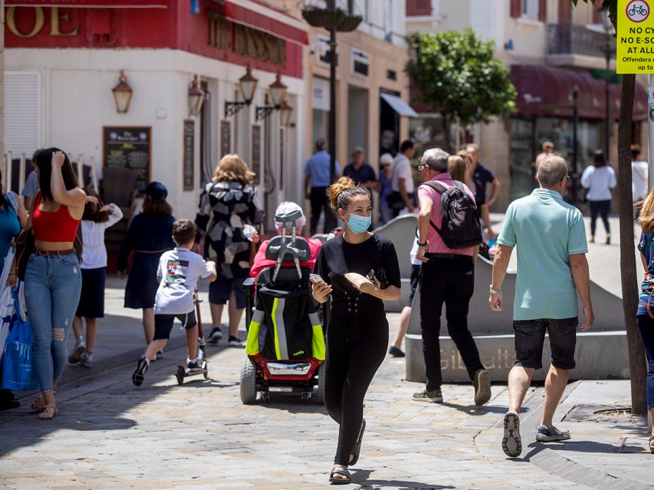 GIBRALTAR - JUNE 1: Pedestrians walk down the main street in Gibraltar. The only Spanish people allo