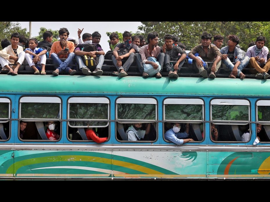 People travel in a crowded bus to return to their cities and villages before the start of the lockdo