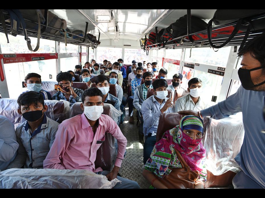 Migrant workers seen crowded inside a bus bound to their native state at Kaushambi Roadways Bus Stan