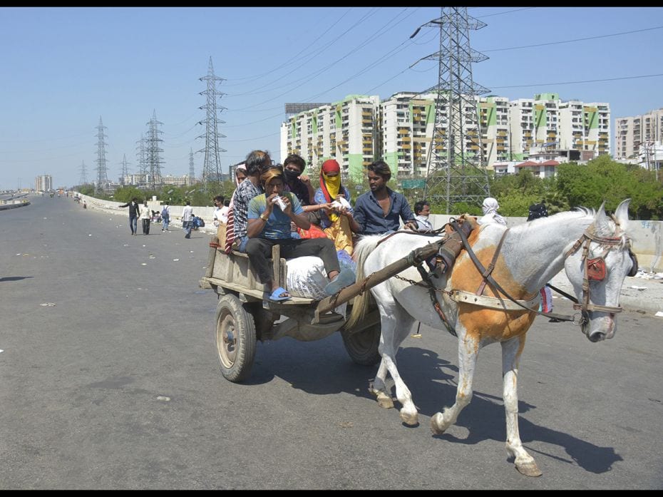 Migrant workers head home on an animal cart during Day 5 of the 21-day nationwide lockdown imposed b