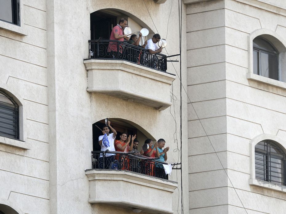 CHENNAI: People stand on their own, separate balconies to clap and make noise with kitchenware at Pr