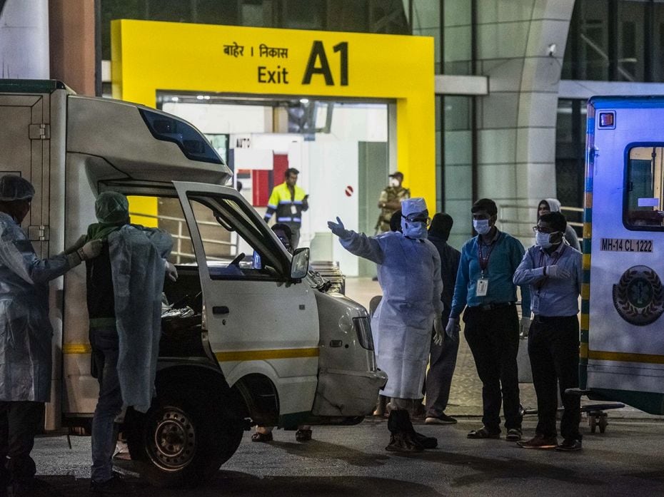 PUNE, March 13: A team of medical staff stands outside an ambulance at Pune International airport, t