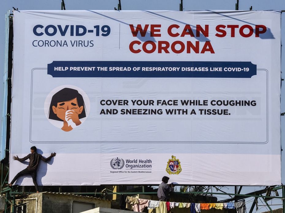 MUMBAI, March 16: A worker fixes a billboard that displays a public service message on how to preven