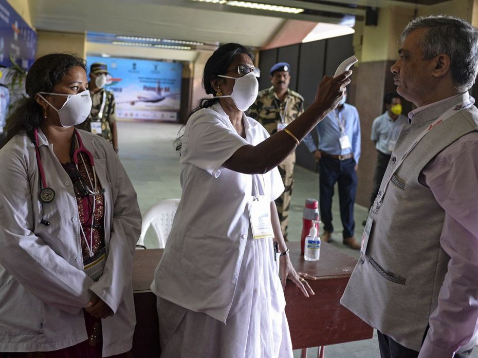 HYDERABAD, March 13: A staff member checks the temperature of visitors and exhibitors at the entranc